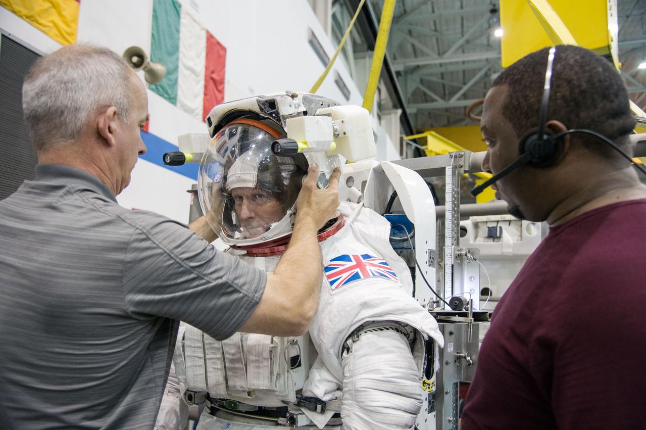 European Astronaut Tim Peake of ESA during ISS EVA MAINT 3 NBL Training with Astronaut Tim Kopra and instructor Sandy Moore. Photo Date: September 10, 2014. Location: NBL - Pool Topside. Photographer: Robert Markowitz