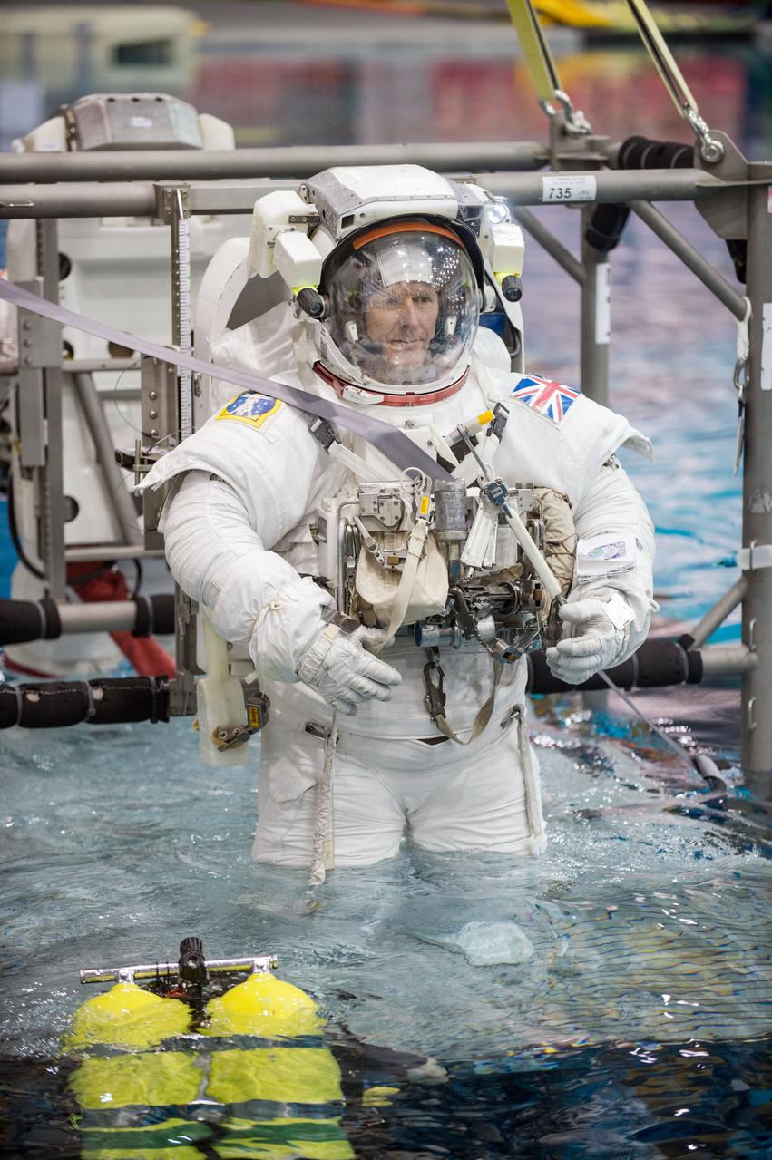 European Astronaut Tim Peake of ESA during ISS EVA MAINT 3 NBL Training with Astronaut Tim Kopra and instructor Sandy Moore. Photo Date: September 10, 2014. Location: NBL - Pool Topside. Photographer: Robert Markowitz