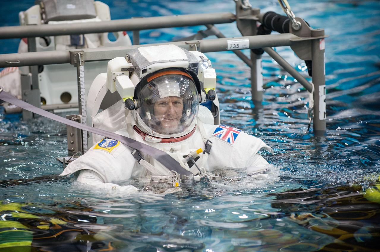 European Astronaut Tim Peake of ESA during ISS EVA MAINT 3 NBL Training with Astronaut Tim Kopra and instructor Sandy Moore. Photo Date: September 10, 2014. Location: NBL - Pool Topside. Photographer: Robert Markowitz