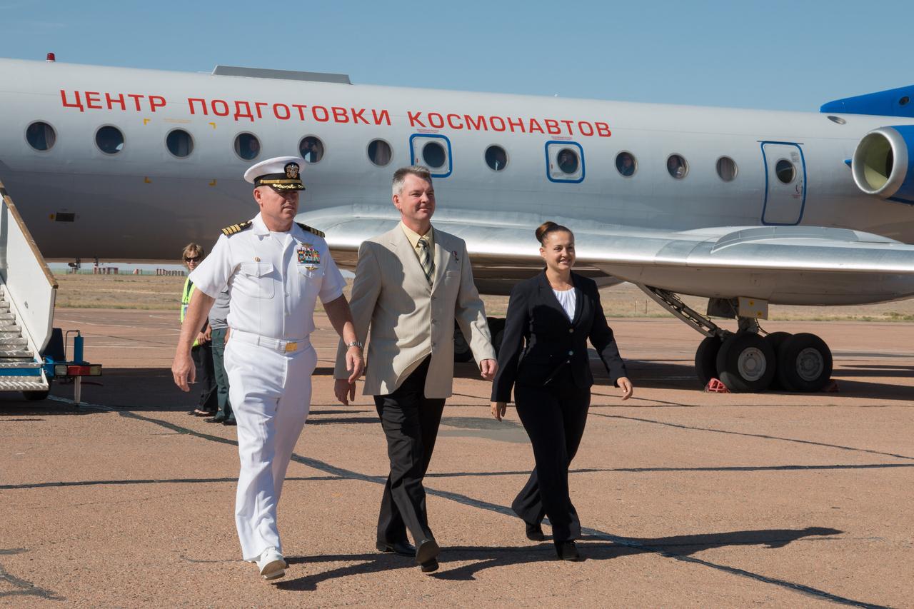 12-16-03-25-2:  Expedition 41/42 Flight Engineer Barry Wilmore of NASA (left), Soyuz Commander Alexander Samokutyaev of the Russian Federal Space Agency (Roscosmos, center) and Flight Engineer Elena Serova of Roscosmos (right) walk off a Gagarin Cosmonaut Training Center plane after arriving at the launch site at the Baikonur Cosmodrome in Kazakhstan Sept. 12 for final pre-launch training. The trio will launch from Baikonur on Sept. 26, Kazakh time, in their Soyuz TMA-14M spacecraft for a 5 ½ month mission on the International Space Station. Serova will become the fourth Russian woman to fly in space.  NASA/Victor Zelentsov 