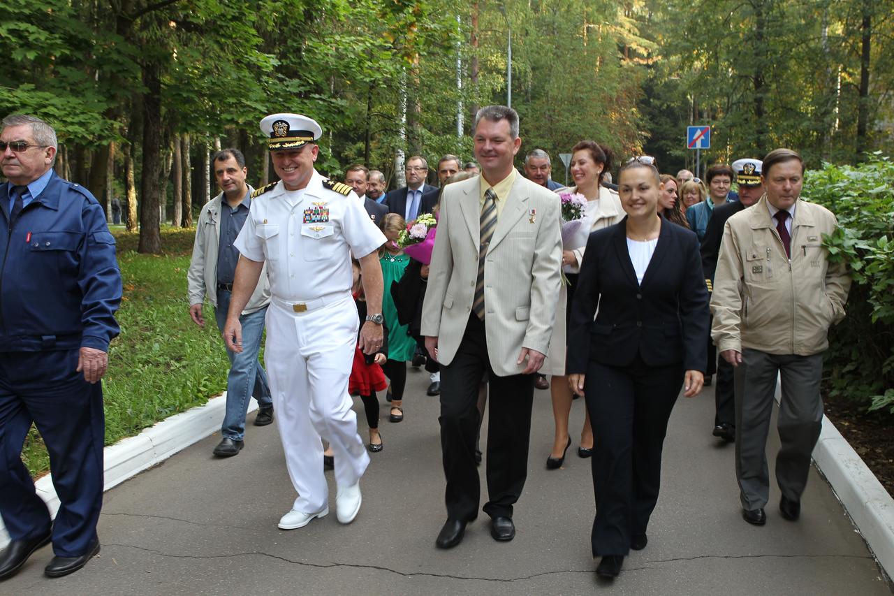 2989:  With family members and officials behind them, Expedition 41/42 Flight Engineer Barry Wilmore of NASA (left), Soyuz Commander Alexander Samokutyaev of the Russian Federal Space Agency (center) and Flight Engineer Elena Serova of Roscosmos (right) walk to a waiting bus at the Gagarin Cosmonaut Training Center in Star City, Russia Sept. 12 before flying to their launch site at the Baikonur Cosmodrome in Kazakhstan for final pre-launch training. The trio will launch from Baikonur on Sept. 26, Kazakh time, in their Soyuz TMA-14M spacecraft for a 5 ½ month mission on the International Space Station. Serova will become the fourth Russian woman to fly in space.  NASA/Stephanie Stoll 