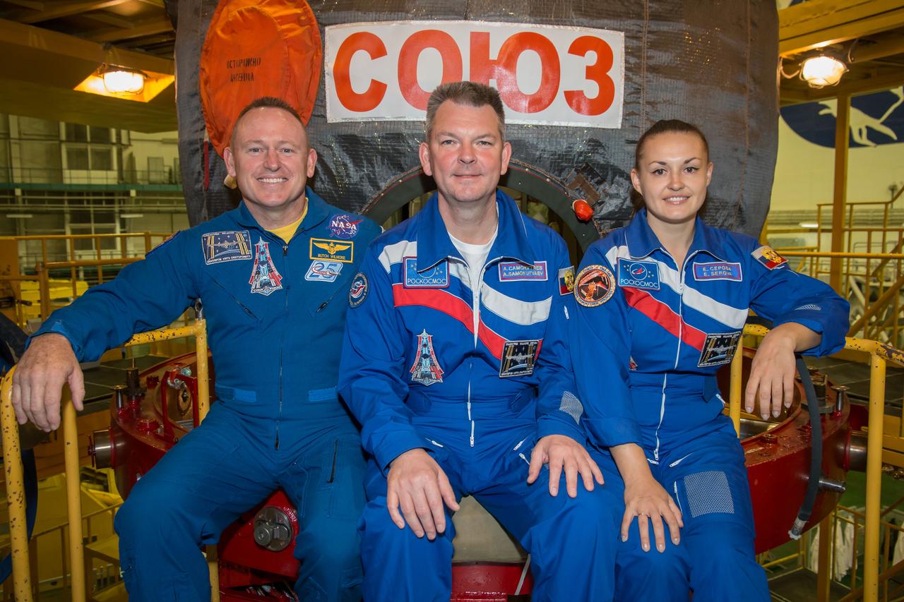 13-10-13-52:     (13 Sept. 2014) --- At the Baikonur Cosmodrome in Kazakhstan, Expedition 41/42 Flight Engineer Barry Wilmore of NASA, left;  Soyuz Commander Alexander Samokutyaev of the Russian Federal Space Agency (Roscosmos), center;  and Flight Engineer Elena Serova of Roscosmos pose for pictures Sept. 13 in front of their Soyuz TMA-14M spacecraft during the first of two “fit check” dress rehearsal activities. The trio will launch on Sept. 26, Kazakh time, in the Soyuz to begin a 5 ½ month mission on the International Space Station. Serova will become the fourth Russian woman to fly in space.  Photo credit: NASA/Victor Zelentsov