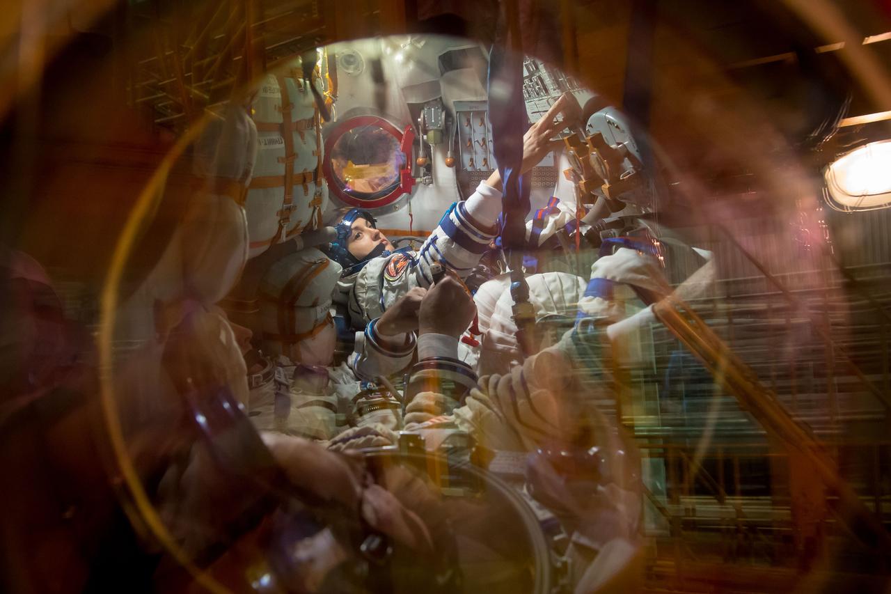 13-13-31-18:     (13 Sept. 2014) --- At the Baikonur Cosmodrome in Kazakhstan, Expedition 41/42 Flight Engineer Elena Serova of the Russian Federal Space Agency (Roscosmos) is seen inside the Soyuz TMA-14M spacecraft Sept. 13 performing test procedures during the first of two “fit check” dress rehearsal activities. Serova, NASA Flight Engineer Barry Wilmore and Soyuz Commander Alexander Samokutyaev of Roscosmos will launch on Sept. 26, Kazakh time, in the Soyuz to begin a 5 ½ month mission on the International Space Station. Serova will become the fourth Russian woman to fly in space. Photo credit: NASA/Victor Zelentsov
