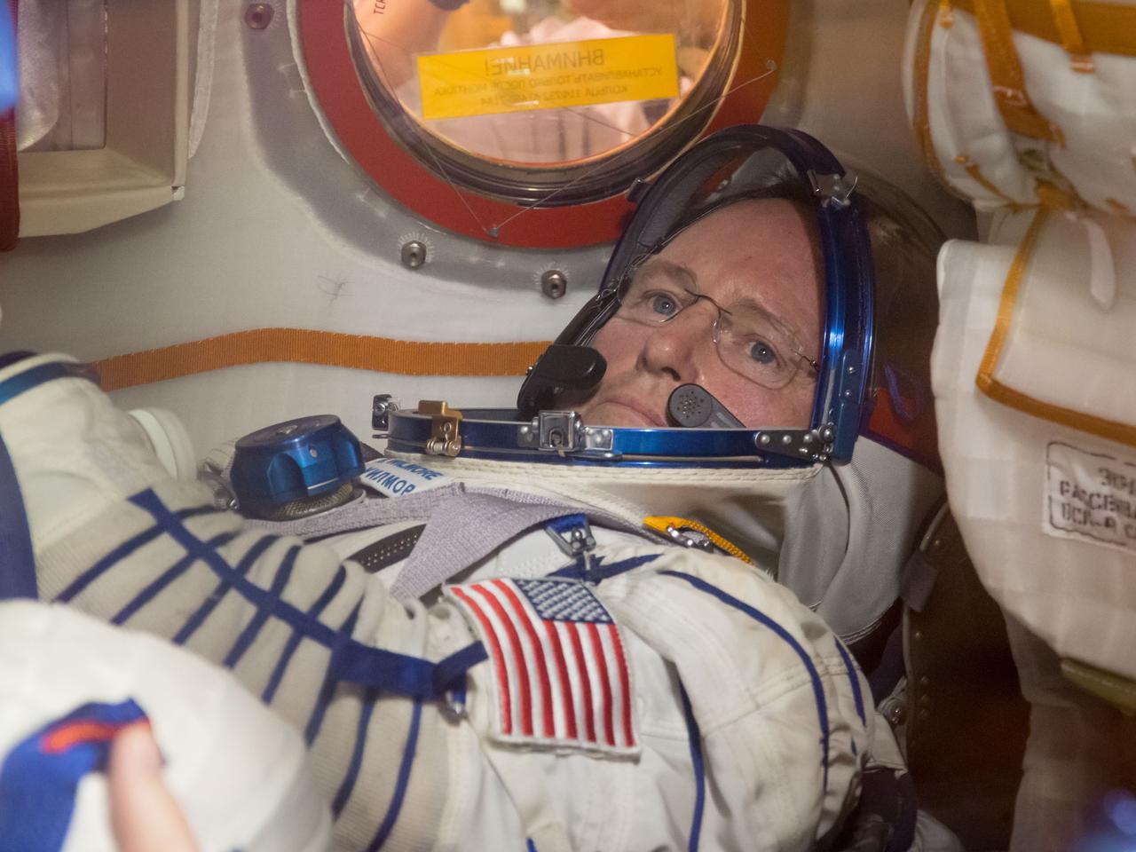 13-13-33-41-3:     (13 Sept. 2014) --- At the Baikonur Cosmodrome in Kazakhstan and clad in his Russian Sokol launch and entry suit, Expedition 41/42 Flight Engineer Barry Wilmore of NASA runs through practice procedures in the Soyuz TMA-14M spacecraft Sept. 13 during the first of two “fit check” dress rehearsal activities. Wilmore, Soyuz Commander Alexander Samokutyaev of the Russian Federal Space Agency (Roscosmos) and Flight Engineer Elena Serova of Roscosmos will launch on Sept. 26, Kazakh time, in the Soyuz to begin a 5 ½ month mission on the International Space Station. Serova will become the fourth Russian woman to fly in space.  Photo credit: ASA/Victor Zelentsov