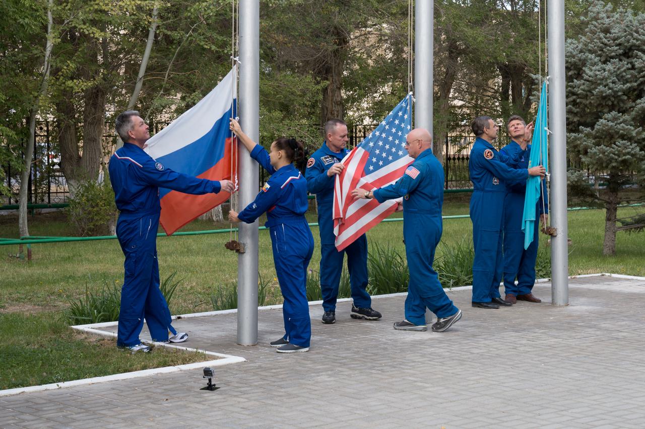 14-11-03-34:     (14 Sept. 2014) --- At their Cosmonaut Hotel crew quarters in Baikonur, Kazakhstan, the Expedition 41/42 prime and backup crew members raised the flags of Russia, the U.S. and Kazakhstan during traditional ceremonies Sept. 14. From left to right are prime crew members Elena Serova and Alexander Samokutyaev of the Russian Federal Space Agency (Roscosmos) raising the Russian flag, prime crew member Barry Wilmore and his backup, Scott Kelly of NASA, raising the American flag, and backup crew members Gennady Padalka and Mikhail Kornienko of Roscosmos raising the flag of Kazakhstan. Wilmore, Samokutyaev and Serova will launch on Sept. 26, Kazakh time, in the Soyuz TMA-14M spacecraft to begin a 5 ½ month mission on the International Space Station. Serova will become the fourth Russian woman to fly in space. Photo credit: NASA/Victor Zelentsov
