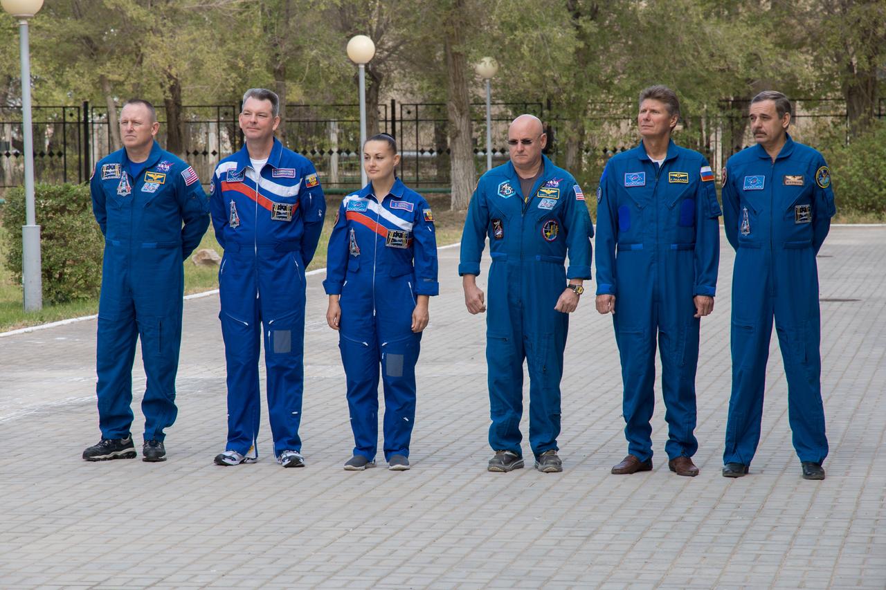 14-11-05-45: (14 Sept. 2014) --- At their Cosmonaut Hotel crew quarters in Baikonur, Kazakhstan, the Expedition 41/42 prime and backup crew members participate in ceremonies after raising the flags of Russia, the U.S. and Kazakhstan during traditional ceremonies Sept. 14. From left to right are prime crew members Barry Wilmore of NASA, Alexander Samokutyaev of the Russian Federal Space Agency (Roscosmos) and Elena Serova of Roscosmos, and backup crew members Scott Kelly of NASA, Gennady Padalka of Roscosmos and and Mikhail Kornienko of Roscosmos. Wilmore, Samokutyaev and Serova will launch on Sept. 26, Kazakh time, in the Soyuz TMA-14M spacecraft to begin a 5 ½ month mission on the International Space Station. Serova will become the fourth Russian woman to fly in space. Photo credit: NASA/Victor Zelentsov