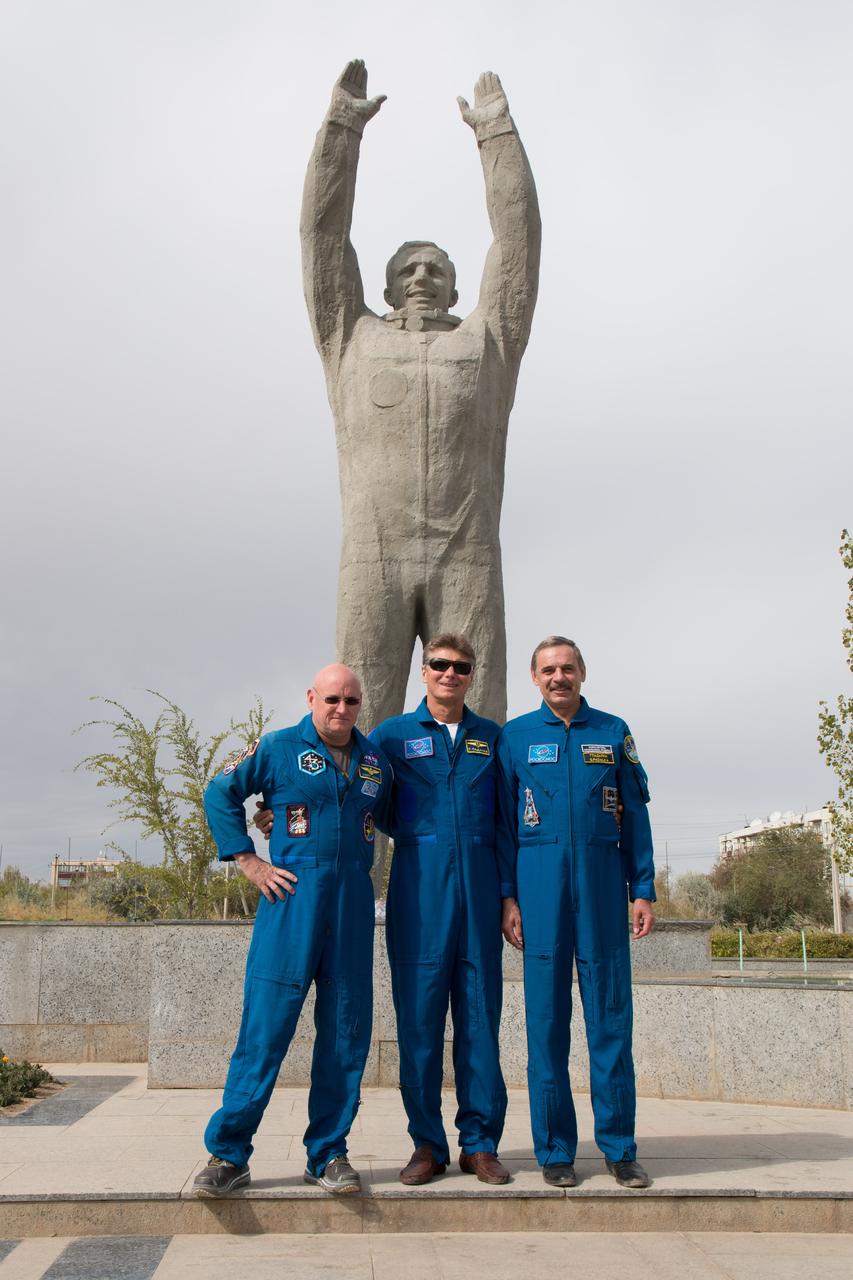 14-12-16-10-2:     (14 Sept. 2014) --- The Expedition 41/42 backup crewmembers pose for pictures in front of a statue of Yuri Gagarin, the first human to fly in space, during a tour of Baikonur, Kazakhstan Sept. 14. From left to right are Scott Kelly of NASA, Gennady Padalka of the Russian Federal Space Agency (Roscosmos) and Mikhail Kornienko of Roscosmos. Kelly and Kornienko will launch from Baikonur in March 2015 to spend a full year on the International Space Station. They are backups to Barry Wilmore of NASA, Alexander Samokutyaev of the Russian Federal Space Agency (Roscosmos) and Elena Serova of Roscosmos. Wilmore, Samokutyaev and Serova will launch on Sept. 26, Kazakh time, in the Soyuz TMA-14M spacecraft to begin a 5 ½ month mission on the station. Serova will become the fourth Russian woman to fly in space.  Photo credit: NASA/Victor Zelentsov