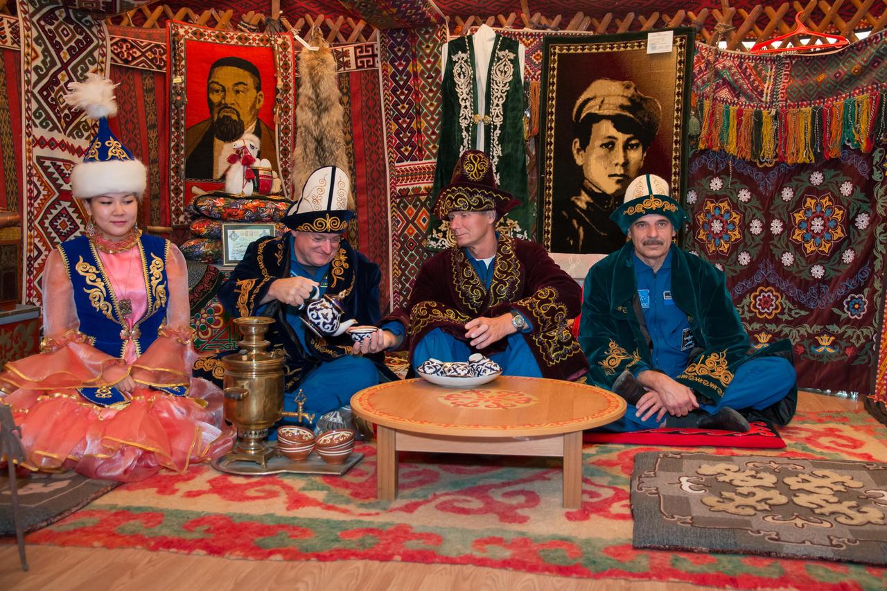 14-12-59-00:     (14 Sept. 2014) --- Wearing native Kazakh clothing, Expedition 41/42 backup crewmembers Scott Kelly of NASA (second from left), Gennady Padalka of the Russian Federal Space Agency (Roscosmos, second from right) and Mikhail Kornienko of Roscosmos (far right) enjoy the ambiance of a traditional Kazakh lunch in a “yurt”, or tent, during a tour of Baikonur, Kazakhstan Sept. 14. Kelly and Kornienko will launch from Baikonur in March 2015 to spend a full year on the International Space Station. They are backups to Barry Wilmore of NASA, Alexander Samokutyaev of the Russian Federal Space Agency (Roscosmos) and Elena Serova of Roscosmos. Wilmore, Samokutyaev and Serova will launch on Sept. 26, Kazakh time, in the Soyuz TMA-14M spacecraft to begin a 5 ½ month mission on the station. Serova will become the fourth Russian woman to fly in space.  NASA/Victor Zelentsov