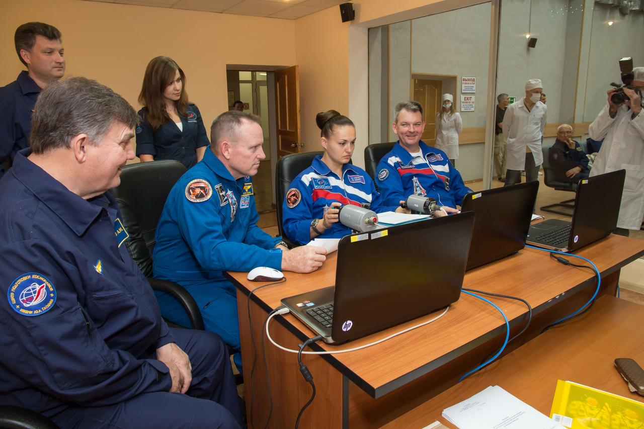 17-11-13-25-2:  (17 Sept. 2014) --- At the Cosmonaut Hotel crew quarters in Baikonur, Kazakhstan, Expedition 41/42 Flight Engineer Elena Serova of the Russian Federal Space Agency (Roscosmos), center,  brushes up on docking skills on a laptop computer simulator Sept. 17 as pre-launch preparations continue for the crew. Looking on are NASA Flight Engineer Barry Wilmore (left) and Soyuz Commander Alexander Samokutyaev of Roscosmos.  The trio will launch from the Baikonur Cosmodrome Sept. 26, Kazakh time, in the Soyuz TMA-14M spacecraft for a 5 ½ month mission on the International Space Station. Serova will become the fourth Russian woman to fly in space and the first Russian woman to live and work on the station.  Photo credit: NASA/Victor Zelentsov 