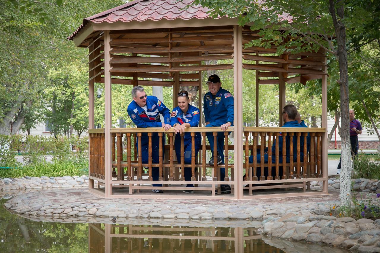 17-14-11-48: (17 Sept. 2014) --- Expedition 41/42 Soyuz Commander Alexander Samokutyaev of the Russian Federal Space Agency (Roscosmos), left; Flight Engineer Elena Serova of Roscosmos (center) and NASA Flight Engineer Barry Wilmore enjoy a moment of relaxation at a gazebo adjacent to their Cosmonaut Hotel crew quarters in Baikonur, Kazakhstan Sept. 17. The trio will launch from the Baikonur Cosmodrome Sept. 26, Kazakh time, in the Soyuz TMA-14M spacecraft for a 5 ½ month mission on the International Space Station. Serova will become the fourth Russian woman to fly in space and the first Russian woman to live and work on the station. Photo credit: NASA/Victor Zelentsov