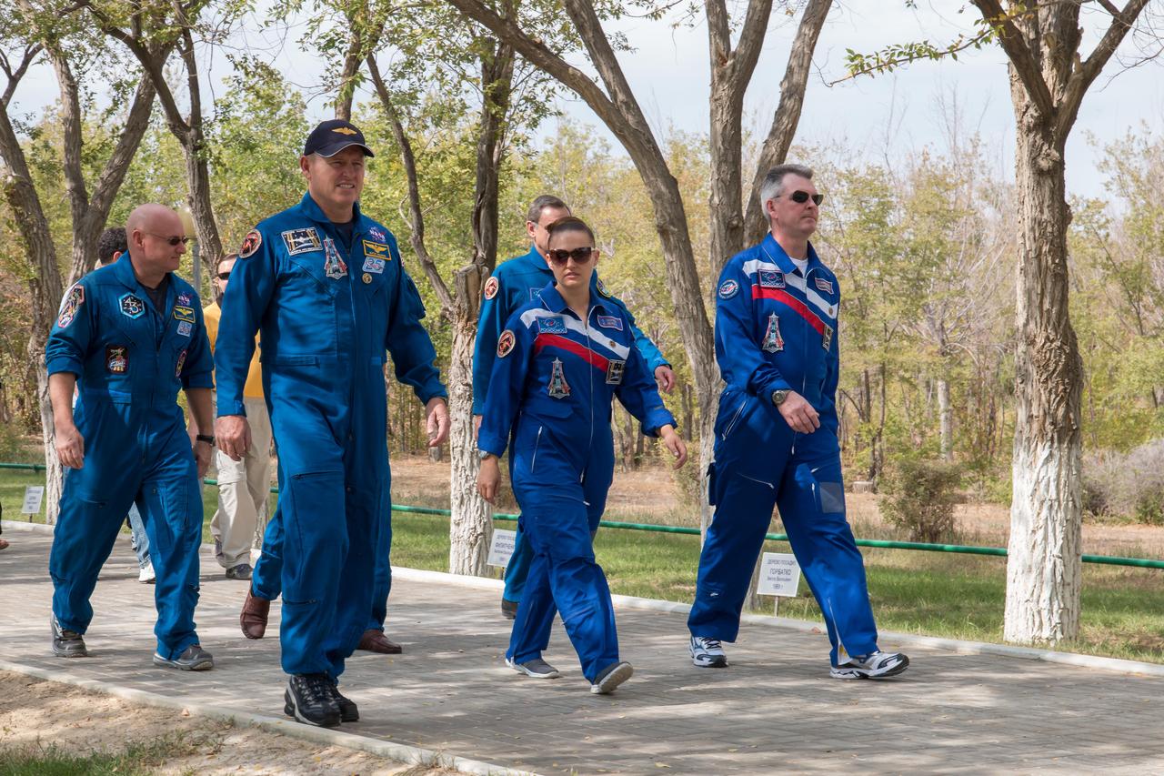 17-14-18-59-3:  (17 Sept. 2014) --- Behind their Cosmonaut Hotel crew quarters in Baikonur, Kazakhstan, Expedition 41 Flight Engineer Barry Wilmore of NASA (front row, left), Flight Engineer Elena Serova of the Russian Federal Space Agency (Roscosmos), center; and Soyuz Commander Alexander Samokutyaev of Roscosmos take a stroll down the Walk of Cosmonauts Sept. 17 as they continue their pre-launch preparations. Behind Wilmore is backup crew member Scott Kelly, who will launch in March 2015 with Mikhail Kornienko to spend a full year on the International Space Station. Wilmore, Serova and Samokutyaev are scheduled to launch from the Baikonur Cosmodrome Sept. 26, Kazakh time, in the Soyuz TMA-14M spacecraft for a 5 ½ month mission on the orbital complex. Serova will become the fourth Russian woman to fly in space and the first Russian woman to live and work on the station.  Photo credit: NASA/Victor Zelentsov 