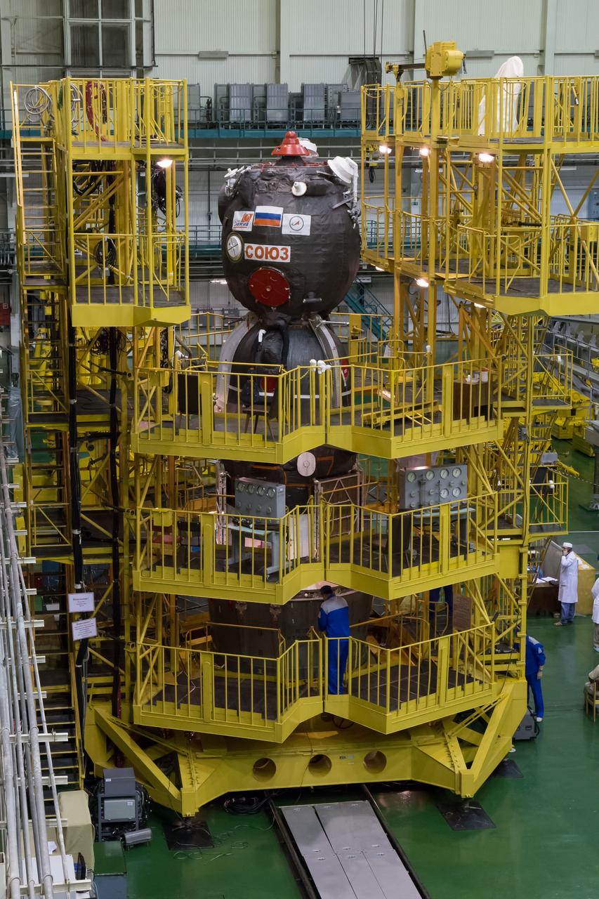 2014-09-18-11-35-10 At the Integration Facility at the Baikonur Cosmodrome in Kazakhstan, the Soyuz TMA-14M spacecraft stands ready for its encapsulation in the upper stage of the Soyuz booster rocket Sept. 18 that will propel it into orbit. The Soyuz will arrive at its launch pad on Sept. 23 for final pre-launch preparations. Expedition 41/42 Flight Engineer Barry Wilmore of NASA, Soyuz Commander Alexander Samokutyaev of the Russian Federal Space Agency (Roscosmos) and Flight Engineer Elena Serova of Roscosmos will launch aboard the Soyuz Sept. 26, Kazakh time, to begin a 5 ½ month mission on the International Space Station. Serova will become the fourth Russian woman to fly in space and the first Russian woman to live and work on the station.  NASA/Victor Zelentsov 