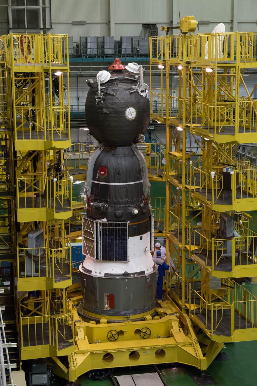 2014-09-18-11-51-19 At the Integration Facility at the Baikonur Cosmodrome in Kazakhstan, the Soyuz TMA-14M spacecraft stands ready for its encapsulation in the upper stage of the Soyuz booster rocket Sept. 18 that will propel it into orbit. The Soyuz will arrive at its launch pad on Sept. 23 for final pre-launch preparations. Expedition 41/42 Flight Engineer Barry Wilmore of NASA, Soyuz Commander Alexander Samokutyaev of the Russian Federal Space Agency (Roscosmos) and Flight Engineer Elena Serova of Roscosmos will launch aboard the Soyuz Sept. 26, Kazakh time, to begin a 5 ½ month mission on the International Space Station. Serova will become the fourth Russian woman to fly in space and the first Russian woman to live and work on the station. NASA/Victor Zelentsov