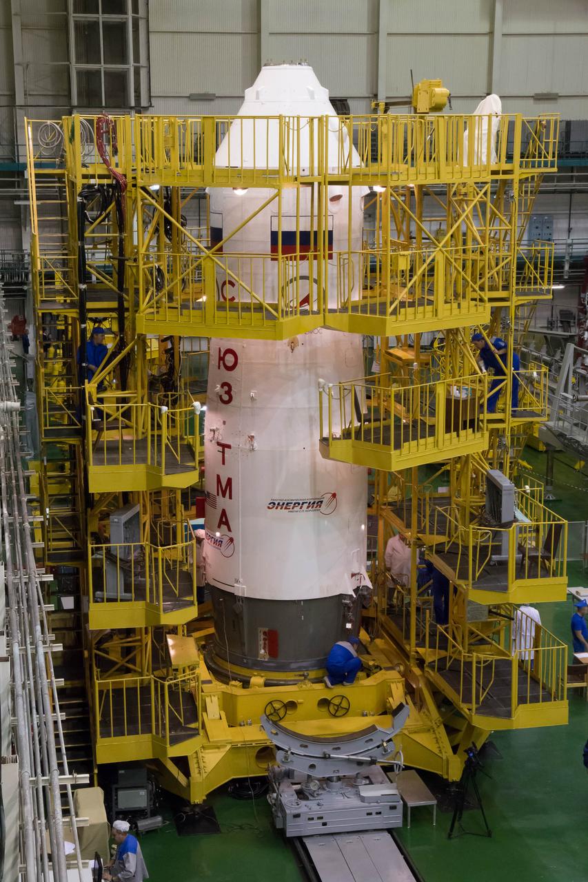 2014-09-18-14-11-15 At the Integration Facility at the Baikonur Cosmodrome in Kazakhstan, work platforms are moved in place around the upper stage of the Soyuz booster rocket after the Soyuz TMA-14M spacecraft was encapsulated inside Sept. 18. The Soyuz will arrive at its launch pad on Sept. 23 for final pre-launch preparations. Expedition 41/42 Flight Engineer Barry Wilmore of NASA, Soyuz Commander Alexander Samokutyaev of the Russian Federal Space Agency (Roscosmos) and Flight Engineer Elena Serova of Roscosmos will launch aboard the Soyuz Sept. 26, Kazakh time, to begin a 5 ½ month mission on the International Space Station. Serova will become the fourth Russian woman to fly in space and the first Russian woman to live and work on the station.  NASA/Victor Zelentsov 