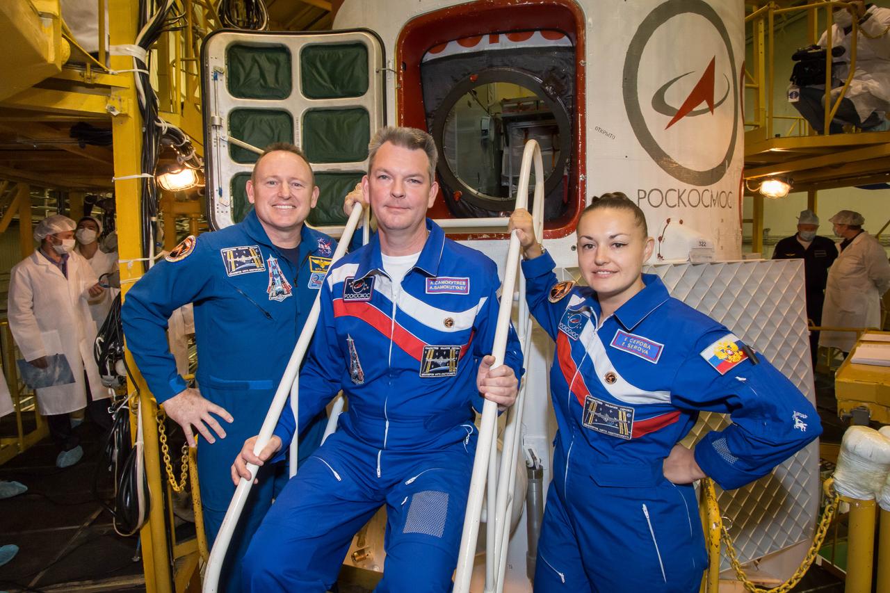 2014-09-21-10-30-41  In the Baikonur Cosmodrome Integration Facility in Kazakhstan, Expedition 41/42 Flight Engineer Barry Wilmore of NASA (left), Soyuz Commander Alexander Samokutyaev of the Russian Federal Space Agency (Roscosmos, center) and Flight Engineer Elena Serova of Roscosmos (right) pose for pictures in front of their Soyuz TMA-14M spacecraft Sept. 21 as they enter the final stages of pre-launch preparations. The trio will launch on Sept. 26, Kazakh time, in the Soyuz to begin a 5 ½ month mission on the International Space Station. Serova will become the fourth Russian woman to fly in space and the first to live and work on the station.  NASA/Victor Zelentsov 