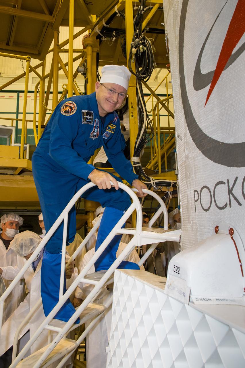 2014-09-21-10-36-51-4 In the Baikonur Cosmodrome Integration Facility in Kazakhstan, Expedition 41/42 Flight Engineer Barry Wilmore of NASA poses for pictures Sept. 21 as he enters the Soyuz TMA-14M spacecraft for a final inspection. Wilmore, Soyuz Commander Alexander Samokutyaev of the Russian Federal Space Agency (Roscosmos) and Flight Engineer Elena Serova of Roscosmos will launch on Sept. 26, Kazakh time, in the Soyuz to begin a 5 ½ month mission on the International Space Station. Serova will become the fourth Russian woman to fly in space and the first to live and work on the station. NASA/Victor Zelentsov