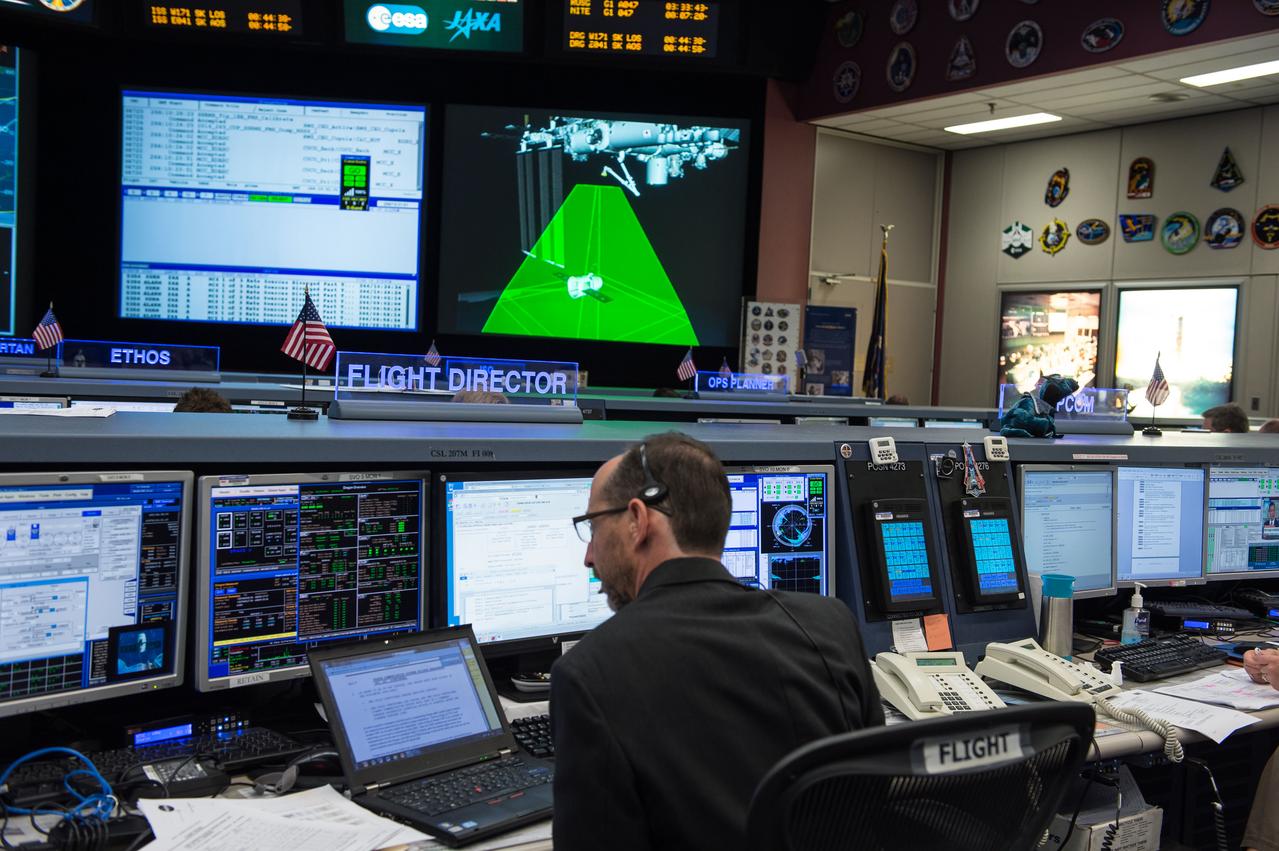 PHOTO DATE: 09/23/14 LOCATION: B30 MCC  SUBJECT: Expedition 41 Flight Controllers on Console in FCR-1 during SpaceX Dragon Capsule Grapple and Berthing. With Flight Director Chris Edelen.  PHOTOGRAPHER: REGAN GEESEMAN 