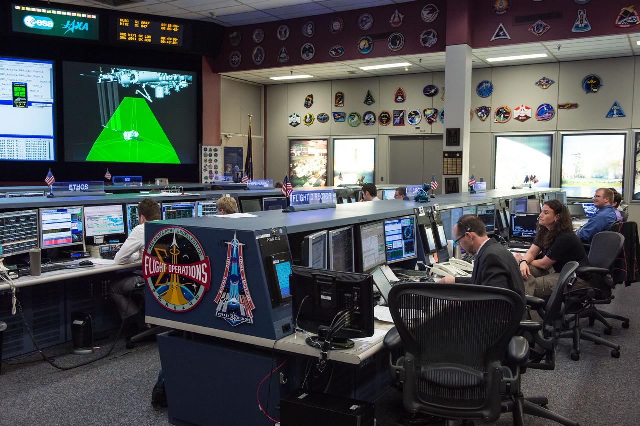PHOTO DATE: 09/23/14 LOCATION: B30 MCC  SUBJECT: Expedition 41 Flight Controllers on Console in FCR-1 during SpaceX Dragon Capsule Grapple and Berthing. With Flight Director Chris Edelen.  PHOTOGRAPHER: REGAN GEESEMAN 