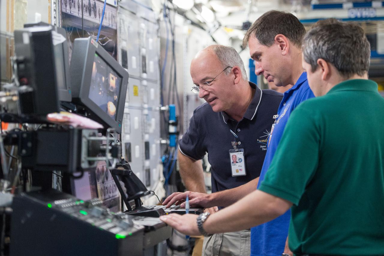 DATE: 9-24-14 LOCATION: Bldg. 9NW - ISS Mockups. SUBJECT: Expedition 48 crew members (Soyuz 46) Aleksey Ovchinin, Oleg Skripochka and Jeff Williams during Routine Ops training in Space Vehicle Mockup Training Facilities (SVMTF) ISS mockups with instructor John Ray. PHOTOGRAPHER: Lauren Harnett
