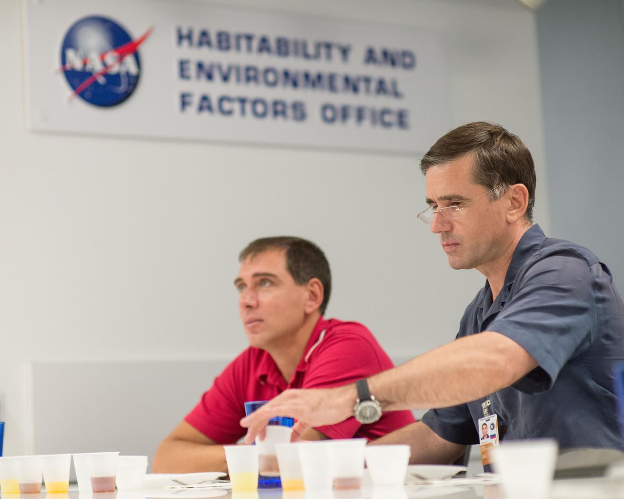 PHOTO DATE: 9-26-14 LOCATION: Bldg. 17, Room 1070 - Food Lab. SUBJECT: Expedition 45 and Soyuz 44 cosmonaut Sergei Volkov with Yuri Malenchenko during Food Tasting in JSC Food Lab. PHOTOGRAPHER: Lauren Harnett