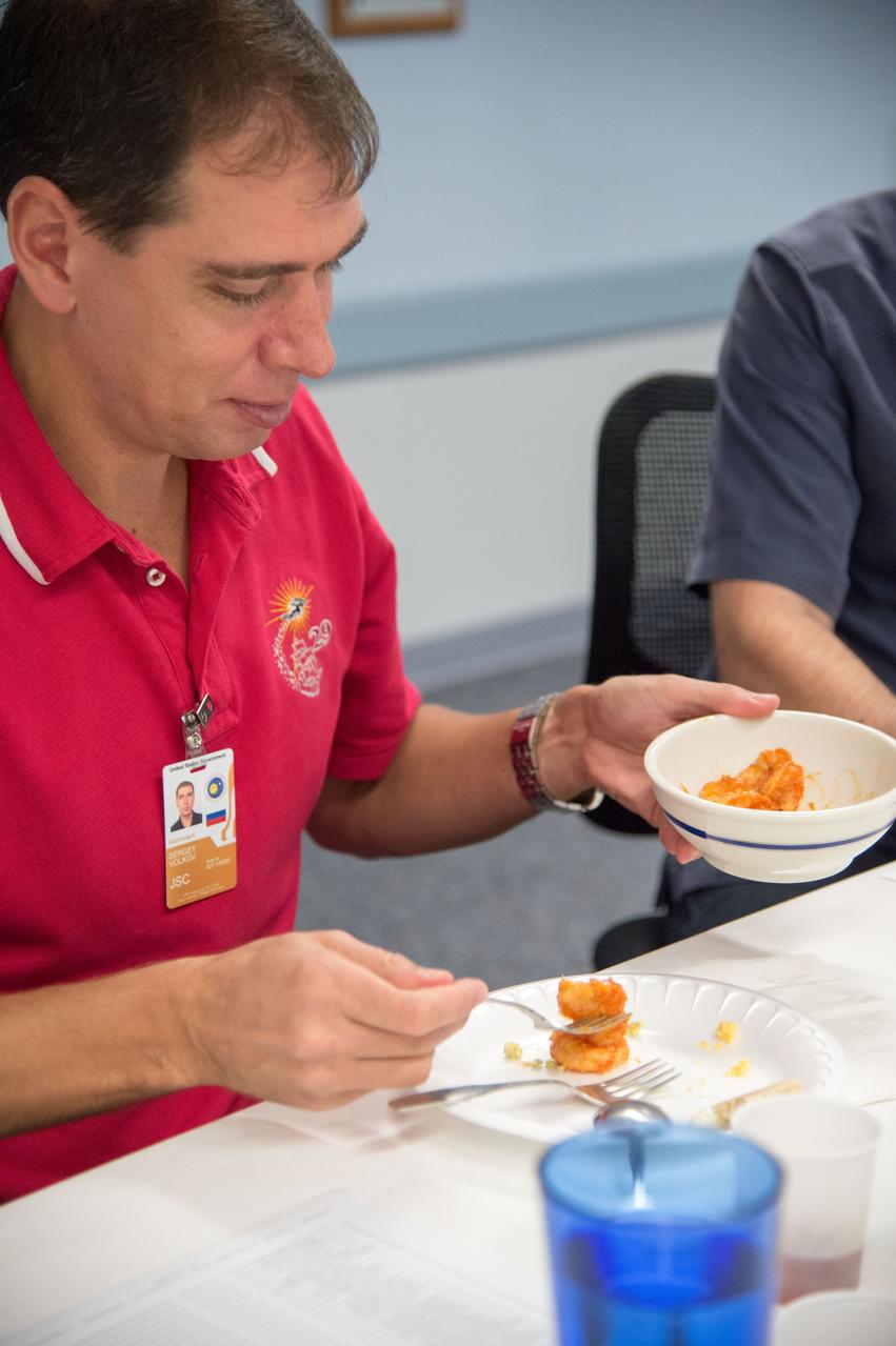 PHOTO DATE: 9-26-14 LOCATION: Bldg. 17, Room 1070 - Food Lab. SUBJECT: Expedition 45 and Soyuz 44 cosmonaut Sergei Volkov with Yuri Malenchenko during Food Tasting in JSC Food Lab. PHOTOGRAPHER: Lauren Harnett