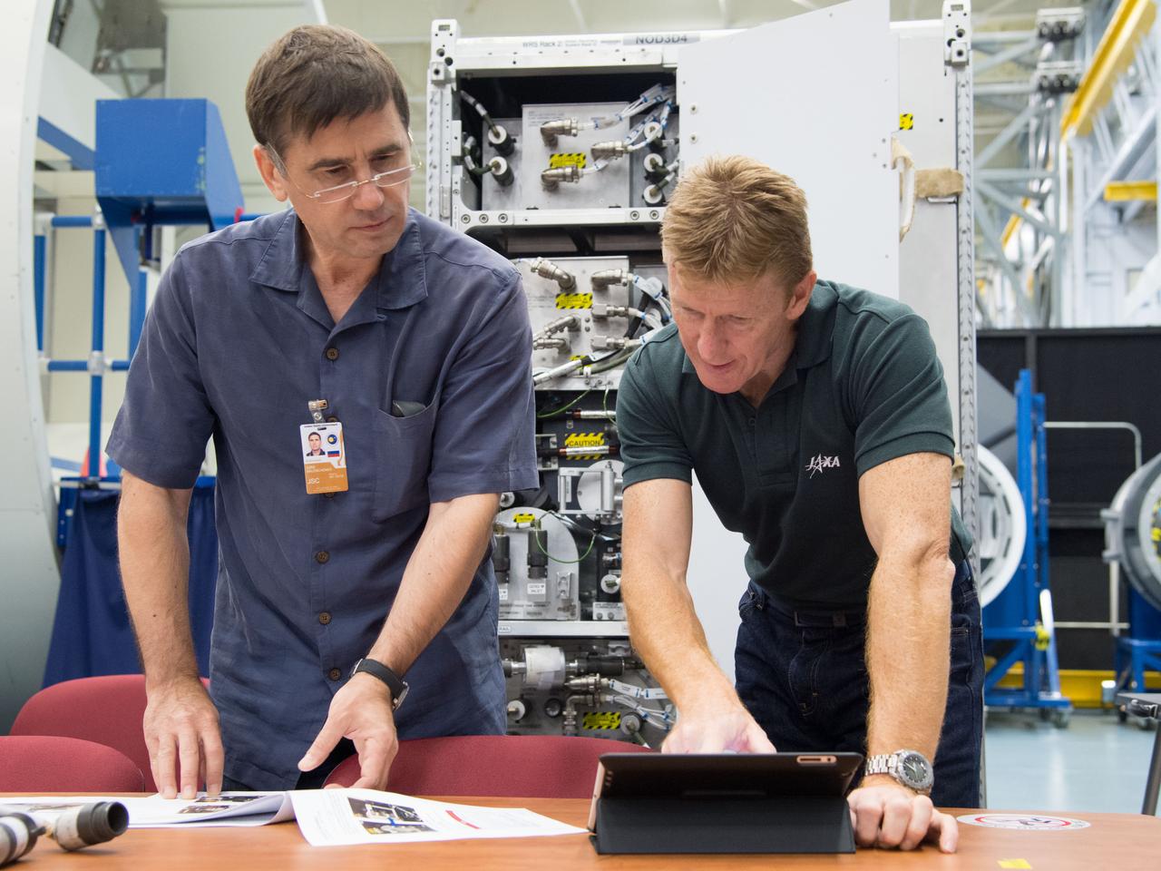Date: 09-30-14 Location: Bldg 9NW, ISS Mockup Subject: Expedition 46/47 (Soyuz 45) crew members Tim Kopra, Timothy Peake, Yuri Malenchenko with instructor Wyatt Smith during Routine Ops training in the Space Vehicle Mockup Training Facility's ISS mockups Photographer: James Blair