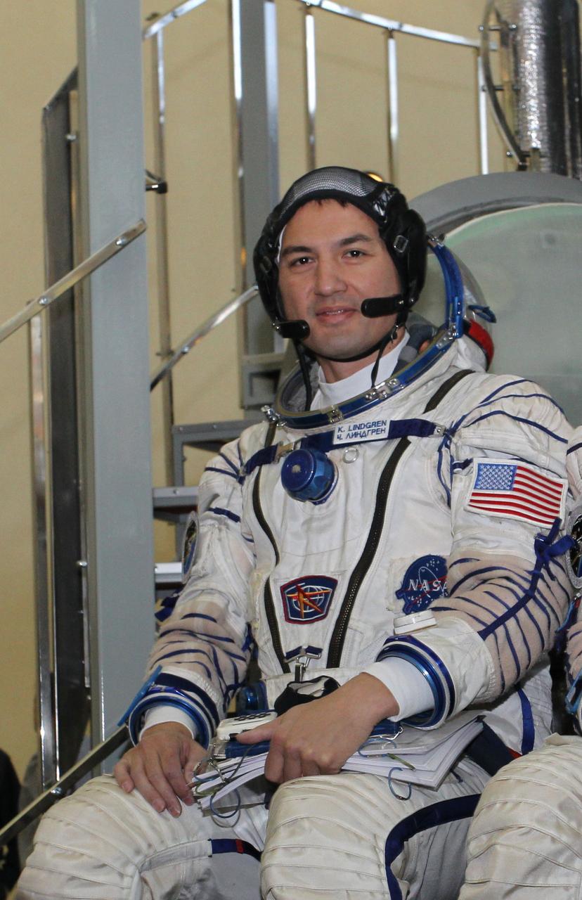 #3234a - (30 October 2014) --- At the Gagarin Cosmonaut Training Center in Star City, Russia, Expedition 42/43 backup Flight Engineer Kjell Lindgren of NASA answers questions from reporters in front of a Soyuz simulator October 30 as part of his final qualification exams for flight. He along with Oleg Kononenko of the Russian Federal Space Agency (Roscosmos) and Kimiya Yui of the Japan Aerospace Exploration Agency (not pictured) are the backups to the prime crew --- Terry Virts of NASA, Anton Shkaplerov of Roscosmos and Samantha Cristoforetti of the European Space Agency --- who are in the final stages of training for launch November 24, Kazakh time, in the Soyuz TMA-15M spacecraft to begin a five and a half month mission on the International Space Station. Photo credit: NASA/Stephanie Stoll