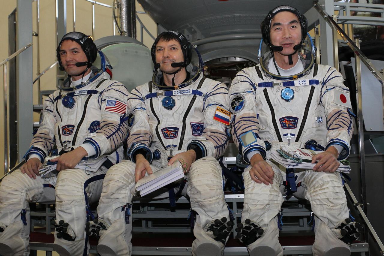 #3241 - (30 October 2014) --- At the Gagarin Cosmonaut Training Center in Star City, Russia, Expedition 42/43 backup crewmembers Kjell Lindgren of NASA (left), Soyuz Commander Oleg Kononenko of the Russian Federal Space Agency (Roscosmos, center) and Kimiya Yui of the Japan Aerospace Exploration Agency (right) answer questions from reporters in front of a Soyuz simulator October 30 as part of their final qualification exams for flight. They are the backups to the prime crew --- Terry Virts of NASA, Anton Shkaplerov of Roscosmos and Samantha Cristoforetti of the European Space Agency --- who are in the final stages of training for launch November 24, Kazakh time, in the Soyuz TMA-15M spacecraft to begin a five and a half month mission on the International Space Station. Photo credit: NASA/Stephanie Stoll