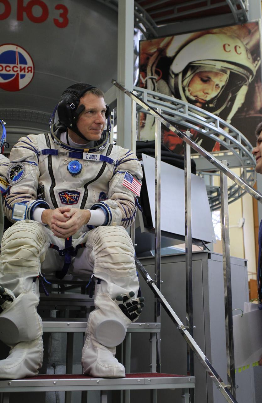 3574a:   At the Gagarin Cosmonaut Training Center in Star City, Russia, Expedition 42/43 Flight Engineer Terry Virts of NASA pauses to reflect as he prepares to enter a Soyuz simulator October 31 for the second day of qualification exams. Overlooking Virts is a wall mural depicting the image of Yuri Gagarin, the first human to fly in space. Virts, Soyuz Commander Anton Shkaplerov of the Russian Federal Space Agency (Roscosmos) and European Space Agency Flight Engineer Samantha Cristoforetti are preparing for launch in the Soyuz TMA-15M spacecraft from the Baikonur Cosmodrome in Kazakhstan Nov. 24, Kazakh time, for a 5 ½ month mission on the International Space Station.  NASA/Stephanie Stoll 