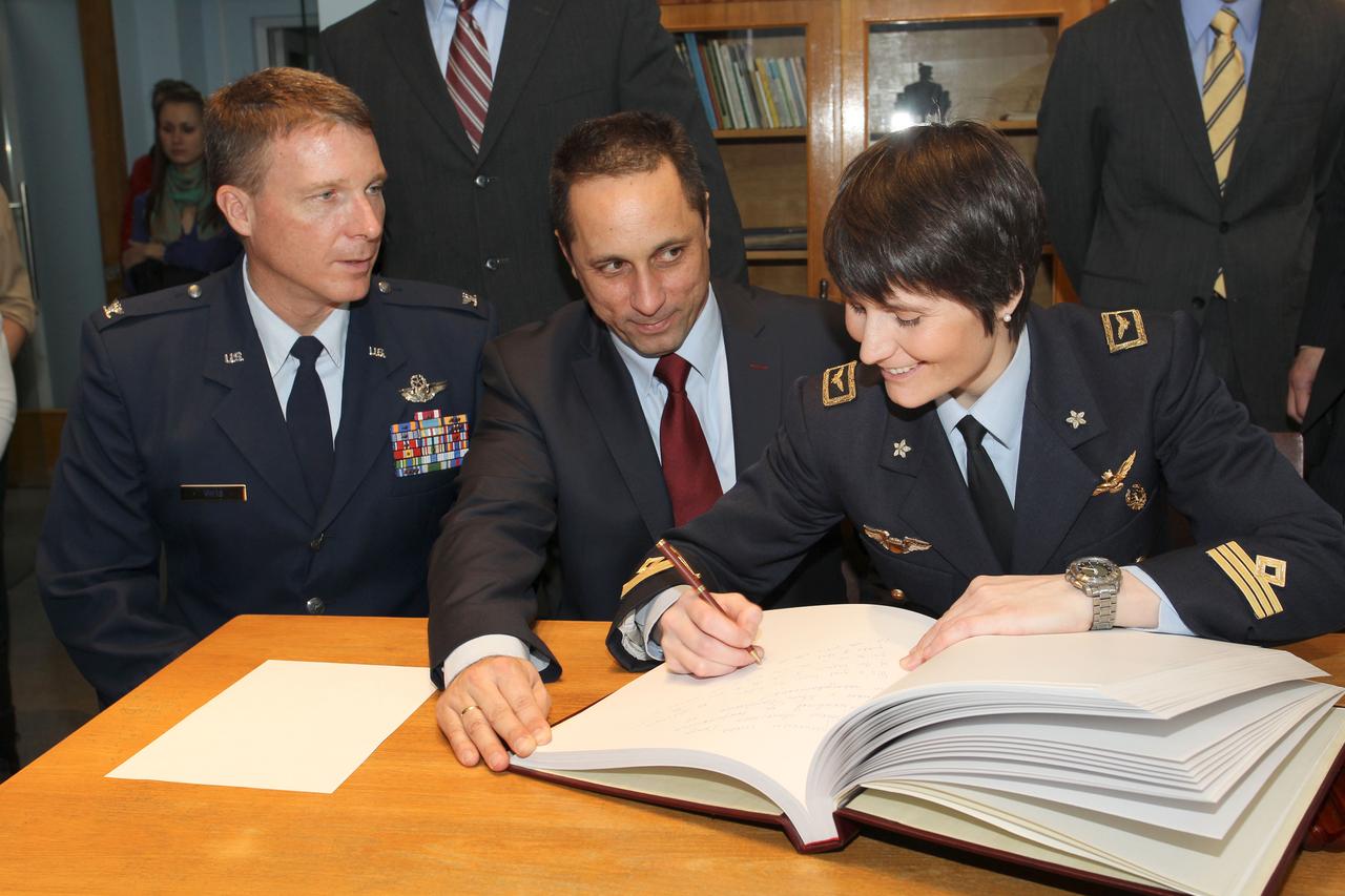 3851:  At the Gagarin Cosmonaut Training Center in Star City, Russia, Expedition 42/43 crewmember Samantha Cristoforetti of the European Space Agency (right) signs a ceremonial book Nov. 6 as her crewmates, Terry Virts of NASA (left) and Anton Shkaplerov of the Russian Federal Space Agency (Roscosmos, center) look on. Virts, Cristoforetti and Shkaplerov will launch Nov. 24, Kazakh time from the Baikonur Cosmodrome in Kazakhstan on their Soyuz TMA-15M spacecraft for a 5 ½ month mission on the International Space Station.  NASA/Stephanie Stoll 