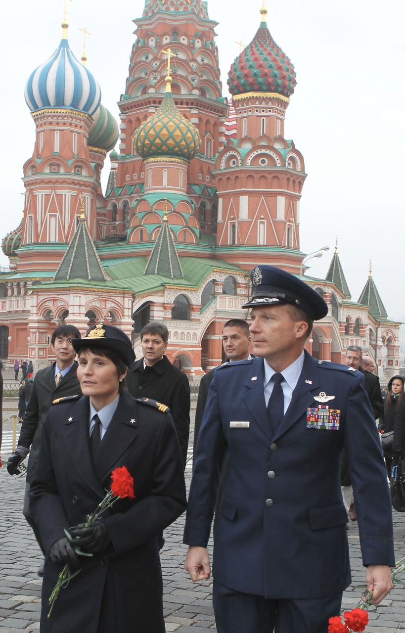 4064a:  In Red Square in Moscow, Expedition 42/43 crewmembers Samantha Cristoforetti of the European Space Agency (foreground, left) and Terry Virts of NASA (foreground, right) walk by the famed St. Basil’s Cathedral Nov. 6 as they prepare to lay flowers at the Kremlin Wall where Russian space icons are interred. In the background are backup crewmembers Kimiya Yui of the Japan Aerospace Exploration Agency, Oleg Kononenko of the Russian Federal Space Agency (Roscosmos) and Kjell Lindgren of NASA. Cristoforetti, Virts and Anton Shkaplerov of Roscosmos will launch Nov. 24, Kazakh time from the Baikonur Cosmodrome in Kazakhstan on their Soyuz TMA-15M spacecraft for a 5 ½ month mission on the International Space Station.  NASA/Stephanie Stoll 