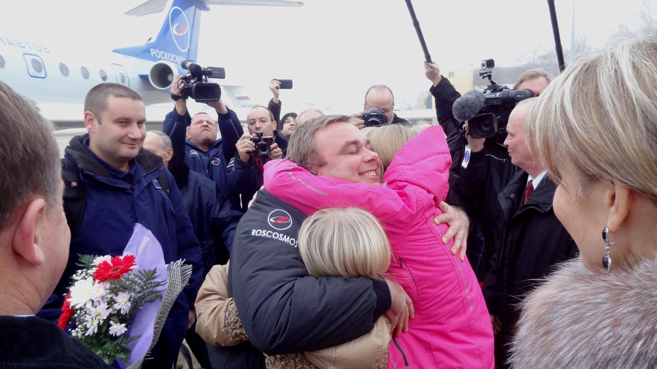 3490a: At Chkalovsky Airfield in Star City, Russia on the outskirts of Moscow, Expedition 41 Commander Max Suraev of the Russian Federal Space Agency (Roscosmos) is greeted by his daughters Nov. 10, just hours after he, NASA Flight Engineer Reid Wiseman and European Space Agency Flight Engineer Alexander Gerst landed in Kazakhstan in their Soyuz TMA-13M spacecraft to complete a 165-day mission on the International Space Station. Suraev completed his second flight in space and has now logged 334 days in space on his two missions.  NASA/Stephanie Stoll 
