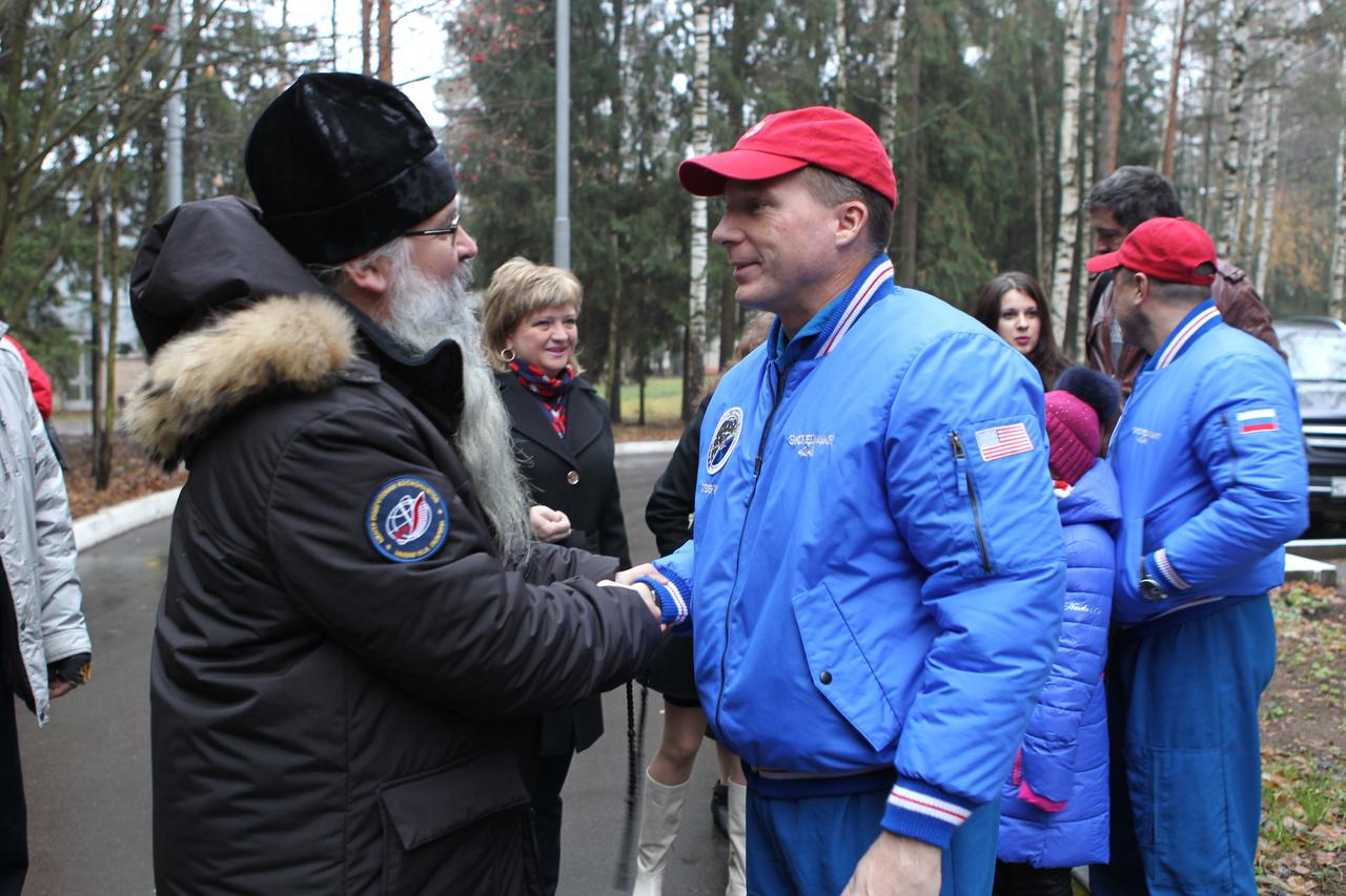 4328:  At the Gagarin Cosmonaut Training Center in Star City, Russia, Expedition 42/43 crewmember Terry Virts of NASA (right) says farewell to a Russian Orthodox priest Nov. 11 before boarding a flight to the Baikonur Cosmodrome in Kazakhstan for final pre-launch training. Virts, Anton Shkaplerov of the Russian Federal Space Agency (Roscosmos) and Samantha Cristoforetti of the European Space Agency will launch Nov. 24, Kazakh time from Baikonur in their Soyuz TMA-15M spacecraft for a five and a half month mission on the International Space Station.  NASA/Stephanie Stoll 