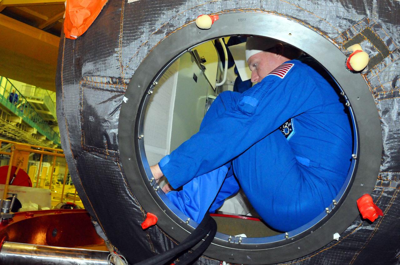 5313: In the Integration Facility at the Baikonur Cosmodrome in Kazakhstan, Expedition 42/43 crewmember Terry Virts of NASA checks out the systems of the Soyuz TMA-15 spacecraft Nov. 12 during a “fit check” dress rehearsal. Virts, Anton Shkaplerov of the Russian Federal Space Agency (Roscosmos) and Samantha Cristoforetti of the European Space Agency will launch Nov. 24, Kazakh time, from Baikonur for a 5 ½ month mission on the International Space Station. NASA/Victor Ivanov