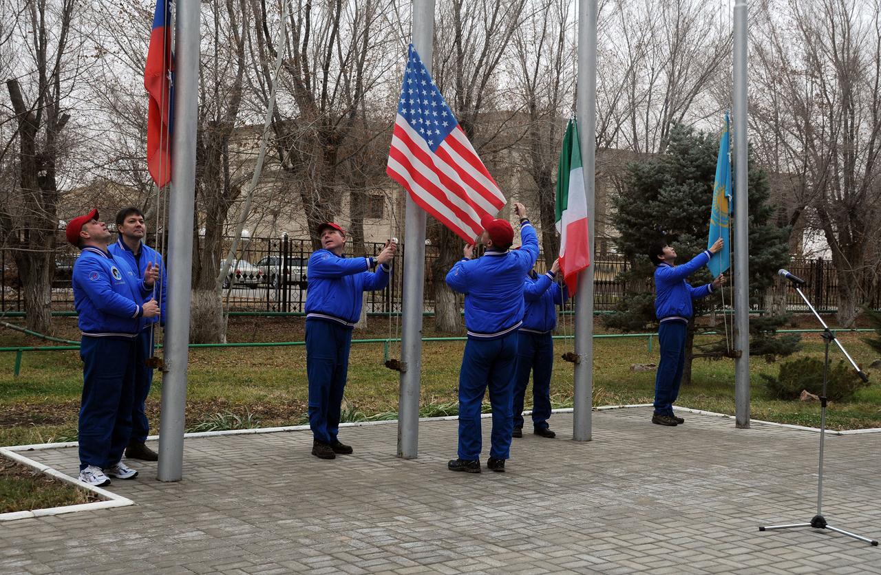 5741:  At their Cosmonaut Hotel crew quarters in Baikonur, Kazakhstan, the Expedition 42/43 prime and backup crewmembers raised the flags of Russia, the U.S., Italy and Kazakhstan in traditional ceremonies Nov. 13. From left to right are prime crewmember Anton Shkaplerov of the Russian Federal Space Agency (Roscosmos) and his backup, Oleg Kononenko, prime crewmember Terry Virts of NASA and his backup, Kjell Lindgren of NASA, prime crewmember Samantha Cristoforetti of the European Space Agency (partially hidden) and backup crewmember Kimiya Yui of the Japan Aerospace Exploration Agency. Virts, Shkaplerov and Cristoforetti will launch Nov. 24, Kazakh time, from Baikonur on the Soyuz TMA-15M spacecraft for a 5 ½ month mission on the International Space Station.  NASA/Victor Ivanov  