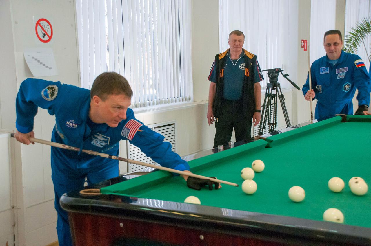5939:  At the Cosmonaut Hotel crew quarters in Baikonur, Kazakhstan, Expedition 42/43 crewmember Terry Virts of NASA (left) tries his hand at billiards Nov. 18 as his Soyuz Commander, Anton Shkaplerov of the Russian Federal Space Agency (Roscosmos, right) looks on. Virts, Shkaplerov and Samantha Cristoforetti of the European Space Agency are preparing to launch Nov. 24, Kazakh time, from the Baikonur Cosmodrome in their Soyuz TMA-15M spacecraft for a 5 ½ month mission on the International Space Station.  NASA/Sergei Fyodorov 