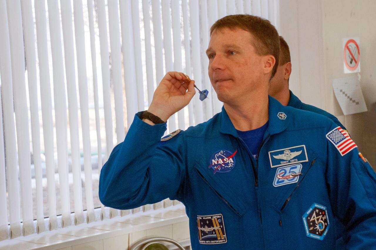 6019:  At the Cosmonaut Hotel crew quarters in Baikonur, Kazakhstan, Expedition 42/43 crewmember Terry Virts of NASA tries his hand at darts Nov. 18 as he prepares for launch Nov. 24, Kazakh time, on the Soyuz TMA-15M spacecraft from the Baikonur Cosmodrome. Virts and his crewmates, Soyuz Commander Anton Shkaplerov of the Russian Federal Space Agency (Roscosmos) and Samantha Cristoforetti of the European Space Agency will spend 5 ½ months on the International Space Station.  NASA/Sergei Fyodorov 