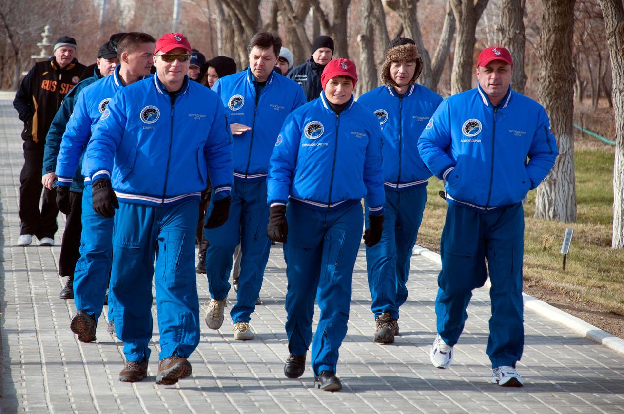 6156:  Bundled up against chilly temperatures, Expedition 42/43 crewmembers Terry Virts of NASA (front row, left), Samantha Cristoforetti of the European Space Agency (front row, center) and Anton Shkaplerov of the Russian Federal Space Agency (Roscosmos, front row, right) take a stroll down the Walk of the Cosmonauts behind their Cosmonaut Hotel crew quarters in Baikonur, Kazakhstan Nov. 18 as part of pre-launch training. Behind them are backup crewmembers Kjell Lindgren of NASA (second row, left), Oleg Kononenko of Roscosmos (second row, center) and Kimiya Yui of the Japan Aerospace Exploration Agency (second row, right). Virts, Cristoforetti and Shkaplerov will launch Nov. 24, Kazakh time, from the Baikonur Cosmodrome in the Soyuz TMA-15M spacecraft for a 5 ½ month mission on the International Space Station.  NASA/Sergei Fyodorov 