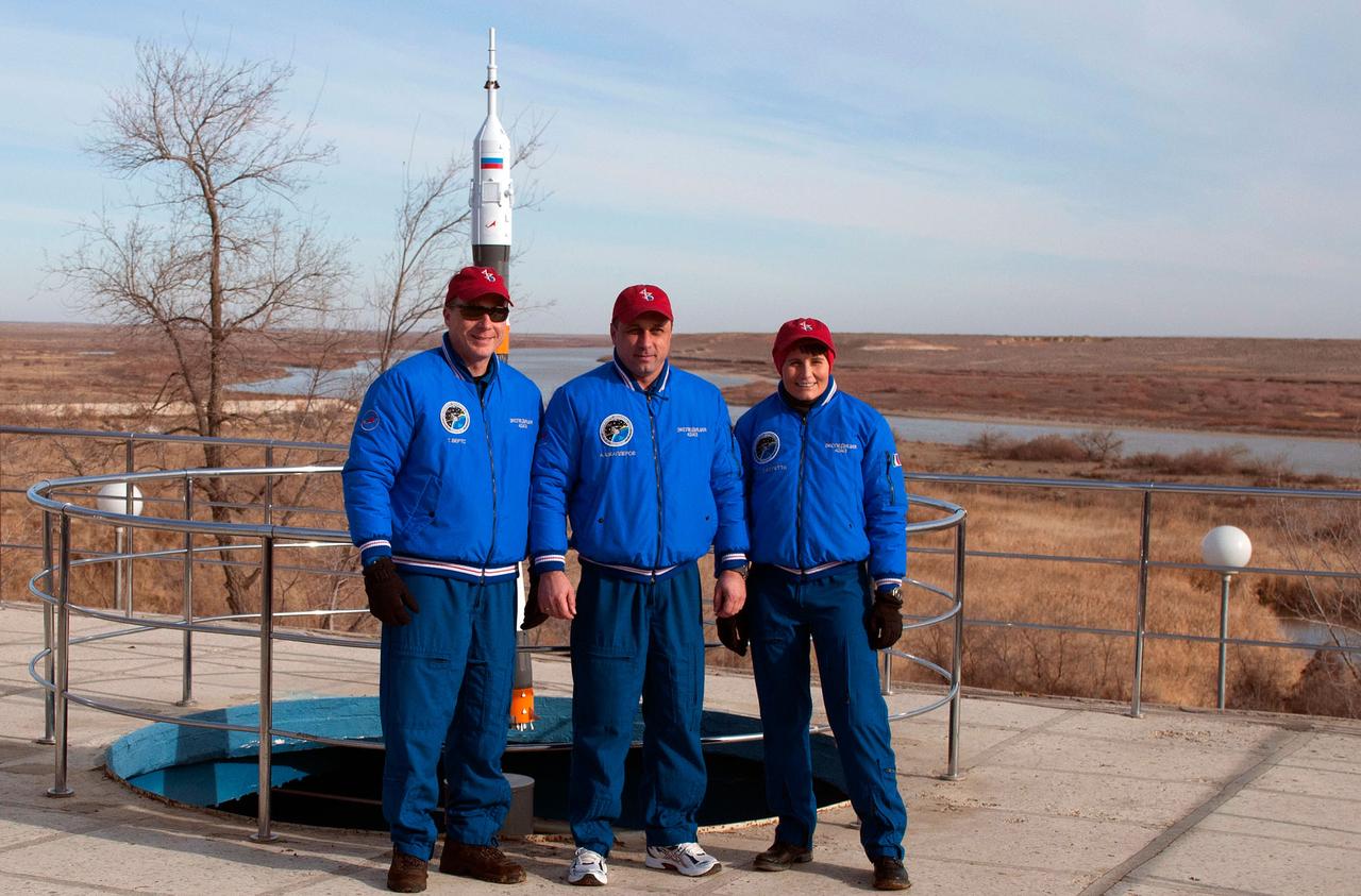 6255:  Behind the Cosmonaut Hotel crew quarters in Baikonur, Kazakhstan, Expedition 42/43 crewmembers Terry Virts of NASA (left), Anton Shkaplerov of the Russian Federal Space Agency (Roscosmos, center) and Samantha Cristoforetti of the European Space Agency (right) pose for pictures Nov. 18 as they near the end of their pre-flight training. Virts, Cristoforetti and Shkaplerov will launch Nov. 24, Kazakh time, from the Baikonur Cosmodrome in the Soyuz TMA-15M spacecraft for a 5 ½ month mission on the International Space Station.  NASA/Sergei Fyodorov 