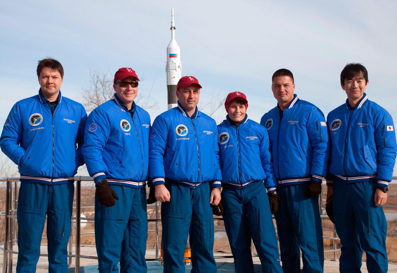 6276:  Behind the Cosmonaut Hotel crew quarters in Baikonur, Kazakhstan, the Expedition 42/43 prime and backup crewmembers pose for pictures Nov. 18 as they near the end of pre-flight training. From left to right are backup crewmember Oleg Kononenko of the Russian Federal Space Agency (Roscosmos), prime crewmembers Terry Virts of NASA, Anton Shkaplerov of Roscosmos and Samantha Cristoforetti of the European Space Agency, and backup crewmembers Kjell Lindgren of NASA and Kimiya Yui of the Japan Aerospace Exploration Agency. Virts, Cristoforetti and Shkaplerov will launch Nov. 24, Kazakh time, from the Baikonur Cosmodrome in the Soyuz TMA-15M spacecraft for a 5 ½ month mission on the International Space Station.  NASA/Sergei Fyodorov 