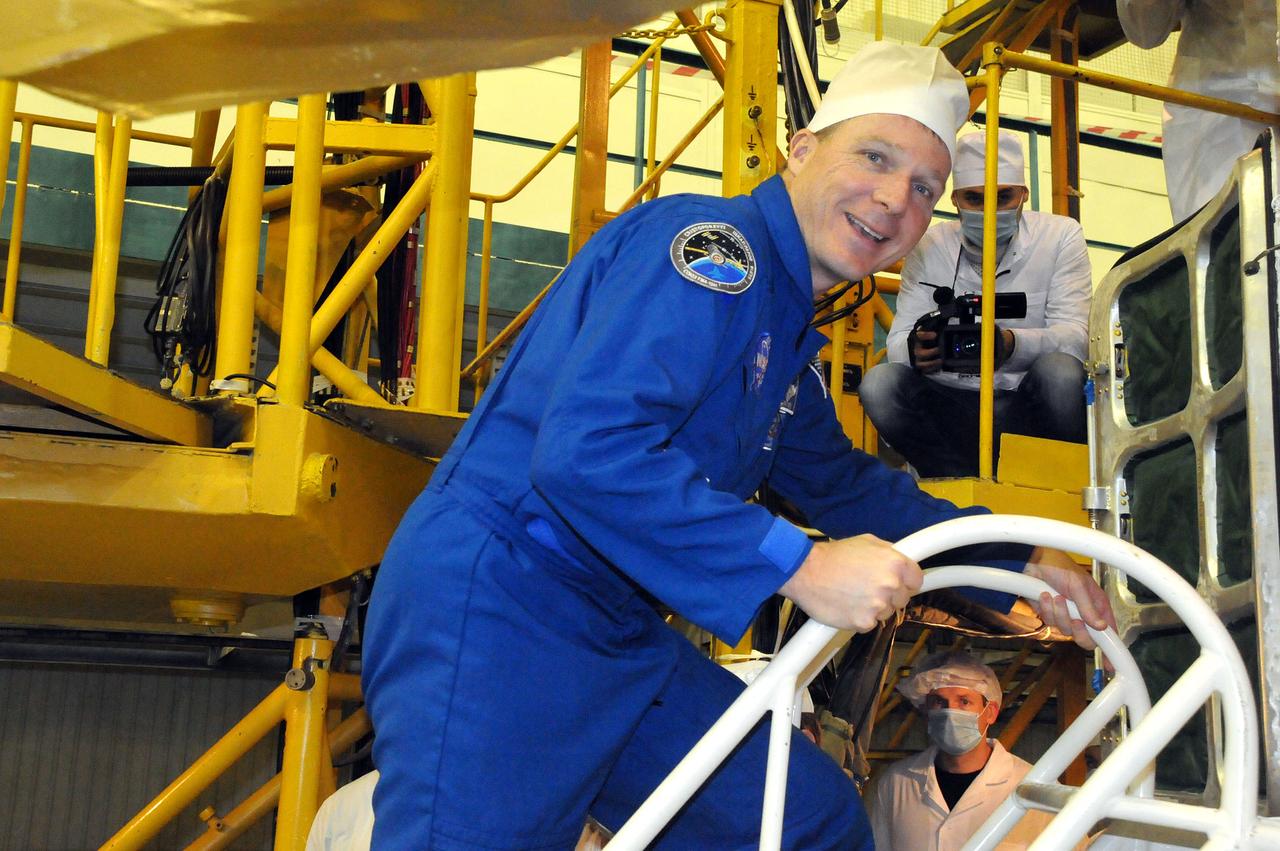 6388:  In the Integration Facility at the Baikonur Cosmodrome in Kazakhstan, Expedition 42/43 crewmember Terry Virts of NASA poses for a picture Nov. 19 by the Soyuz TMA-15M spacecraft during the crew’s second and final pre-launch “fit check” dress rehearsal activities. Virts, Anton Shkaplerov of the Russian Federal Space Agency (Roscosmos) and Samantha Cristoforetti of the European Space Agency will launch on Nov. 24, Kazakh time, from Baikonur for a 5 ½ month mission on the International Space Station.  NASA/Viktor Ivanov 