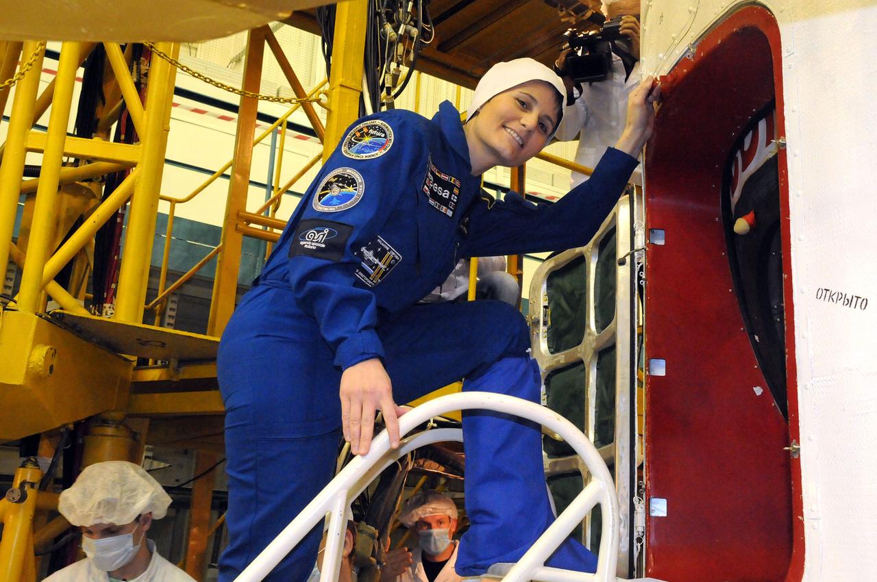 6394:  In the Integration Facility at the Baikonur Cosmodrome in Kazakhstan, Expedition 42/43 crewmember Samantha Cristoforetti of the European Space Agency poses for a picture Nov. 19 by the Soyuz TMA-15M spacecraft during the crew’s second and final pre-launch “fit check” dress rehearsal activities. Cristoforetti,  Terry Virts of NASA and  Anton Shkaplerov of the Russian Federal Space Agency (Roscosmos) will launch on Nov. 24, Kazakh time, from Baikonur for a 5 ½ month mission on the International Space Station.  NASA/Viktor Ivanov 