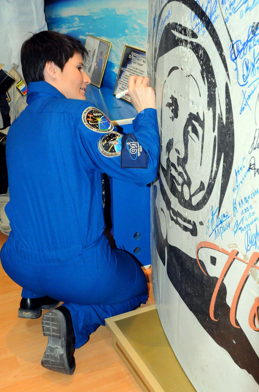 6443:  Inside the Korolev Museum at the Baikonur Cosmodrome in Kazakhstan, Expedition 42/43 crewmember Samantha Cristoforetti of the European Space Agency signs a wall mural depicting space milestones including the likeness of Yuri Gagarin, the first human to fly in space, during ceremonial pre-launch activities Nov. 19. Cristoforetti,  Terry Virts of NASA and  Anton Shkaplerov of the Russian Federal Space Agency (Roscosmos) will launch on Nov. 24, Kazakh time, from Baikonur for a 5 ½ month mission on the International Space Station.  NASA/Viktor Ivanov 