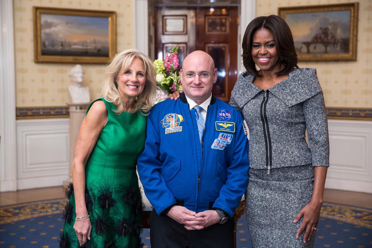 First Lady Michelle Obama and Dr. Jill Biden greet Scott Kelly, First Lady's State of the Union box guest, in the Blue Room of the White House, Jan. 20, 2015. (Official White House Photo by Lawrence Jackson) P012015LJ-0103  This official White House photograph is being made available only for publication by news organizations and/or for personal use printing by the subject(s) of the photograph. The photograph may not be manipulated in any way and may not be used in commercial or political materials, advertisements, emails, products, promotions that in any way suggests approval or endorsement of the President, the First Family, or the White House.