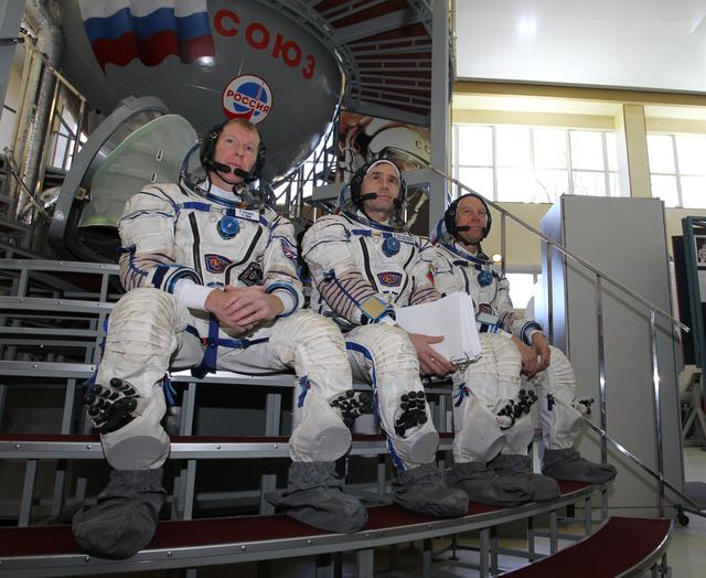 NASA image: CG4G8796_1 --- (6 May 2015) --- At the Gagarin Cosmonaut Training Center in Star City, Russia, Expedition 44/45 backup crewmembers Timothy Peake of the European Space Agency (left), Yuri Malenchenko of the Russian Federal Space Agency (Roscosmos, center) and Timothy Kopra of NASA (right) answer questions from reporters in front of a Soyuz spacecraft simulator May 6 as part of their final qualification exams for flight. They are the backups to the prime crew --- Kjell Lindgren of NASA, Oleg Kononenko of Roscosmos and Kimya Yui of the Japan Aerospace Exploration Agency --- who are in the final stages of training for launch May 27, Kazakh time, in the Soyuz TMA-17M spacecraft to begin a five and a half month mission to the International Space Station. Photo credit: NASA/Seth Marcantel