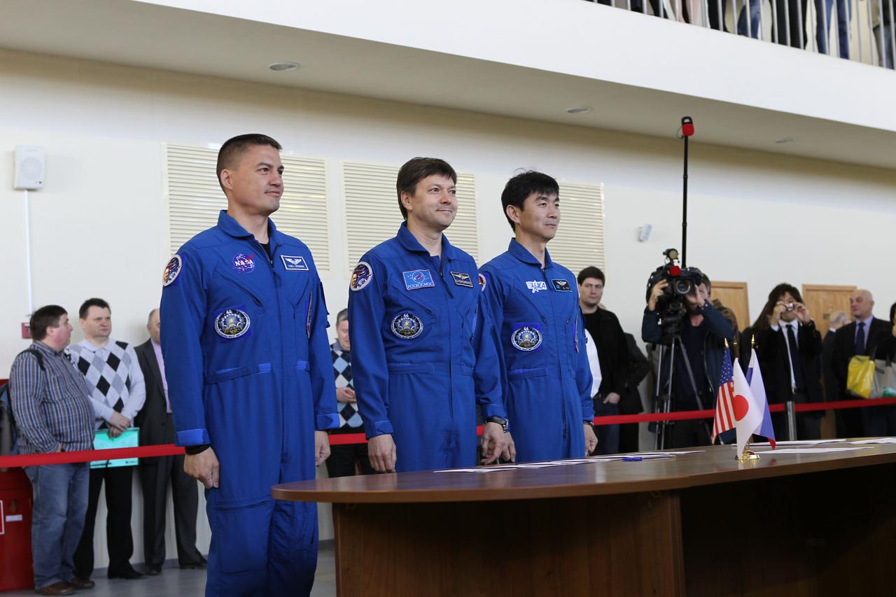 CG4G8889 --- (6 May 2015) --- At the Gagarin Cosmonaut Training Center in Star City, Russia, Expedition 44/45 crewmembers Kjell Lindgren of NASA (left), Oleg Kononenko of the Russian Federal Space Agency (Roscosmos, center), and Kimya Yui of the Japan Aerospace Exploration Agency (right) appear before Russian space officials on the first of two days of qualification exams May 6. The trio is preparing for launch from the Baikonur Cosmodrome in Kazakhstan on May 27, Kazakh time, in the Soyuz TMA-17M spacecraft to begin a five and a half month mission to the International Space Station. Photo credit: NASA/Seth Marcantel