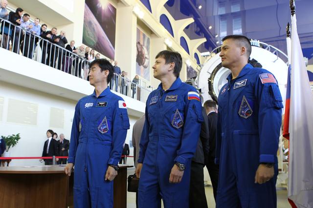 NASA image: CG4G8954 --- (6 May 2015) --- At the Gagarin Cosmonaut Training Center in Star City, Russia, Expedition 44/45 crewmembers Kimya Yui of the Japan Aerospace Exploration Agency (left), Oleg Kononenko of the Russian Federal Space Agency (Roscosmos, center), and Kjell Lindgren of NASA (right) answer questions from media on the first of two days of qualification exams May 6. The trio is preparing for launch from the Baikonur Cosmodrome in Kazakhstan on May 27, Kazakh time, in the Soyuz TMA-17M spacecraft to begin a five and a half month mission to the International Space Station. Photo credit: NASA/Seth Marcantel