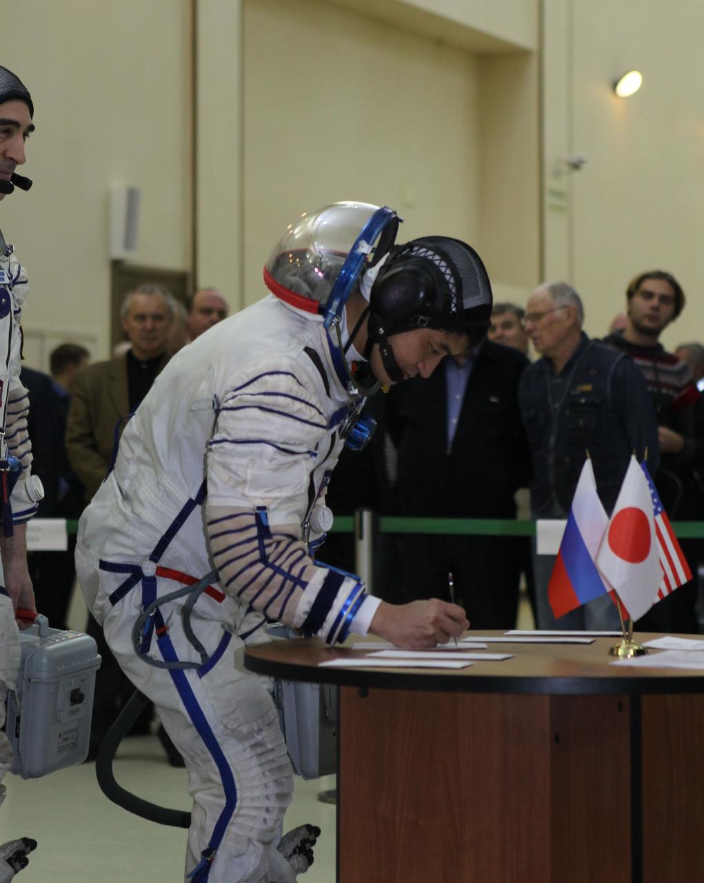At the Gagarin Cosmonaut Training Center in Star City, Russia, Expedition 46-47 backup crewmember Takuya Onishi of the Japan Aerospace Exploration Agency signs in Nov. 19 for the start of qualification exams. Onishi as his crewmates, Kate Rubins of NASA and Anatoly Ivanishin of the Russian Federal Space Agency (Roscosmos) are the backups to the prime crewmembers, Yuri Malenchenko of Roscosmos, Tim Kopra of NASA and Tim Peake of the European Space Agency, who will launch Dec. 15 in the Soyuz TMA-19M spacecraft from the Baikonur Cosmodrome in Kazakhstan for a six-month mission on the International Space Station. NASA/Seth Marcantel