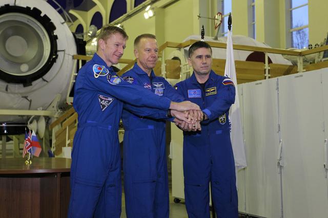 NASA image: At the Gagarin Cosmonaut Training Center in Star City, Russia, Expedition 46-47 prime crewmembers Tim Peake of the European Space Agency (left), Tim Kopra of NASA (center) and Yuri Malenchenko of the Russian Federal Space Agency (Roscosmos, right) pose for pictures Nov. 19 at the start of two days of qualification exams. They will launch Dec. 15 in the Soyuz TMA-19M spacecraft from the Baikonur Cosmodrome in Kazakhstan for a six-month mission on the International Space Station..NASA/Seth Marcantel