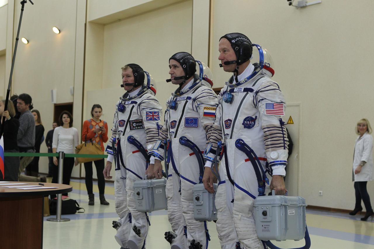 At the Gagarin Cosmonaut Training Center in Star City, Russia, Expedition 46-47 crewmembers Tim Peake of the European Space Agency (left), Yuri Malenchenko of the Russian Federal Space Agency (Roscosmos, center) and Tim Kopra of NASA (right) report for their qualification exams Nov. 20. The trio will launch Dec. 15 on their Soyuz TMA-19M spacecraft Dec. 15 from the Baikonur Cosmodrome in Kazakhstan for a six-month mission on the International Space Station. NASA/Seth Marcantel